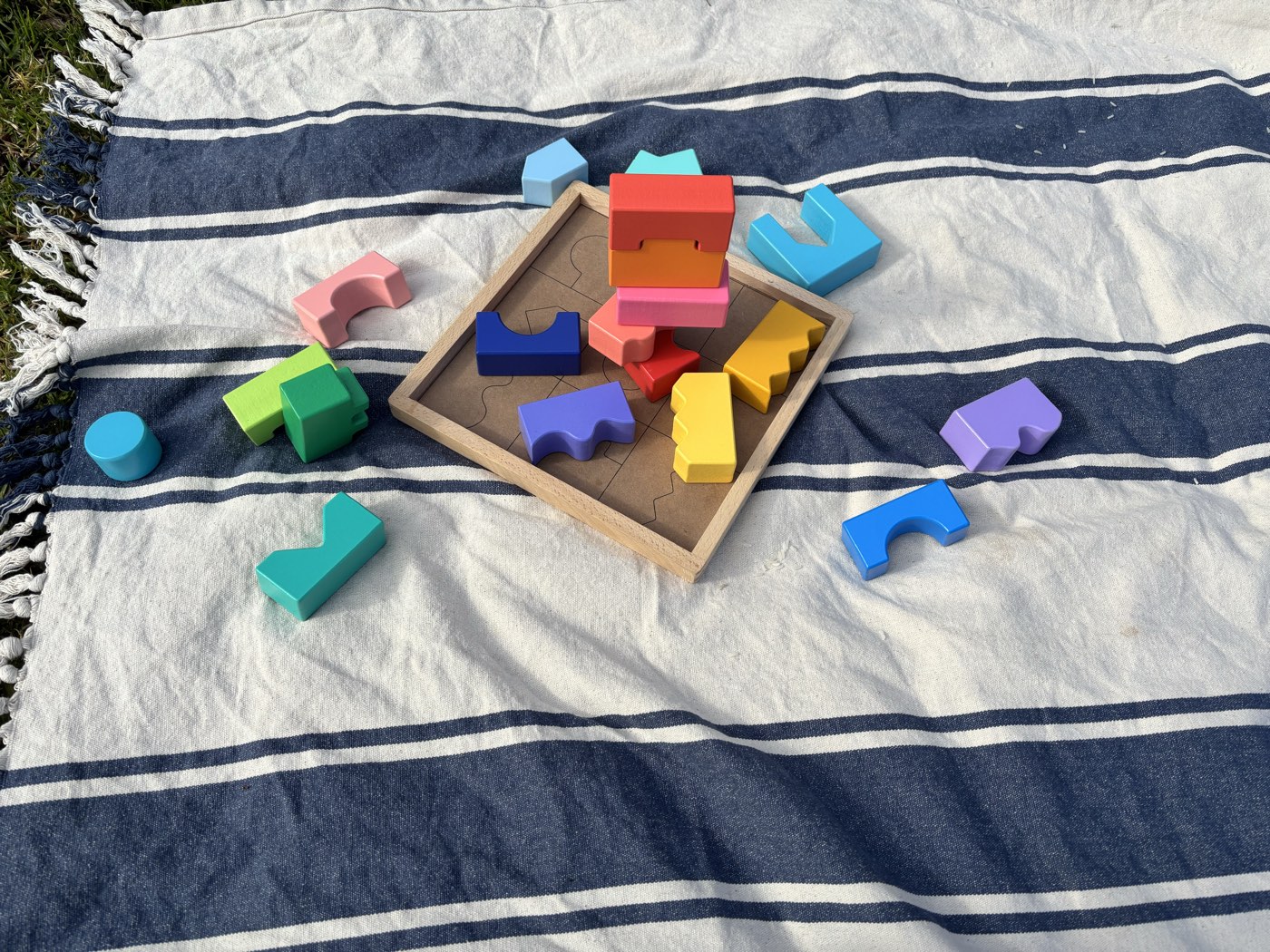 Colourful wooden puzzle blocks spread out ready for play