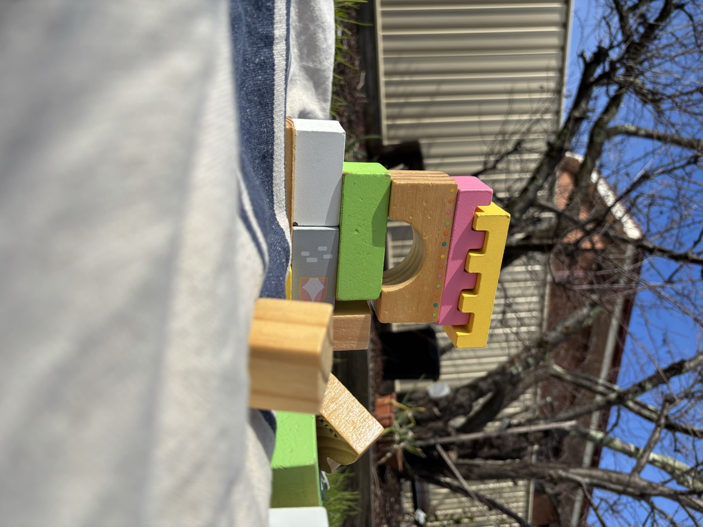 A wooden block castle built in the backyard sunshine